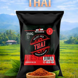 Bag of Velvet Red Thai spice with a bowl of spice in front, set against a scenic background.