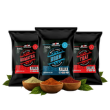 Three black spice packages with labels and three wooden bowls of spices on a white background.