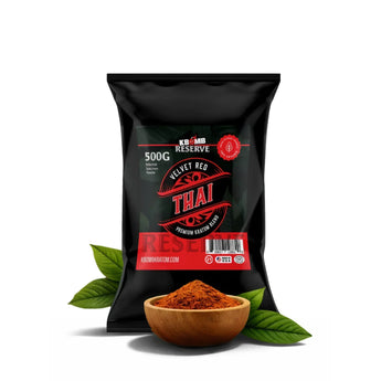 Black package of 'Kombo Reserve' velvet red Thai spice with a wooden bowl of spice and leaves on a white background