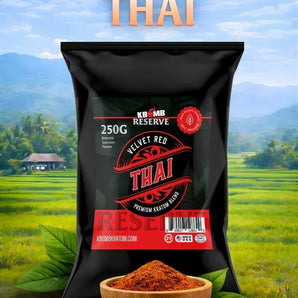 Bag of Velvet Red Thai spice with a bowl of spice in front, set against a scenic background.