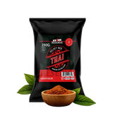 Black package of Velvet Red Thai spice with a wooden bowl of spice and leaves on a white background