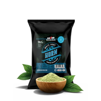 Black package of KBomb Reserve White Ivory Horn with a bowl of green powder and leaves on a white background