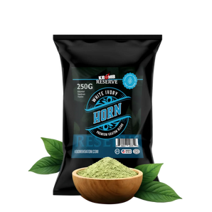 Black package of KBomb Reserve White Ivory Horn with a bowl of green powder and leaves on a white background