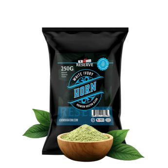 Black package of KBomb Reserve White Ivory Horn with a bowl of green powder and leaves on a white background